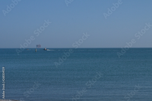 fishing boat in sea,blue,sky,calm, fishing,water,horizon,