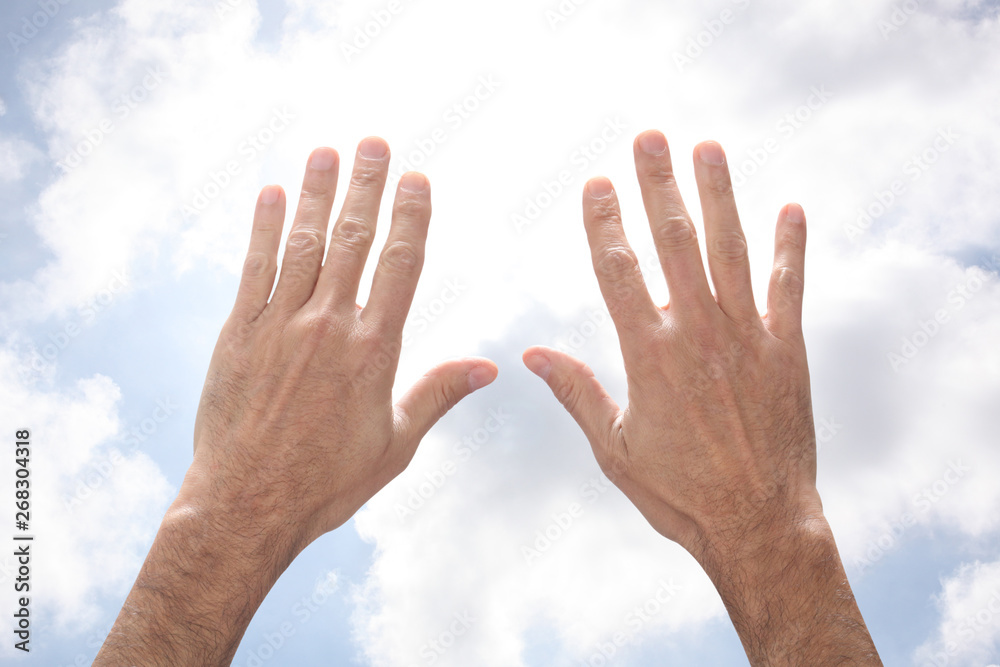 open man's hands rising to the sky in a pray gesture with copy space for your text open man's hands rising to the sky in a pray gesture with copy space for your text