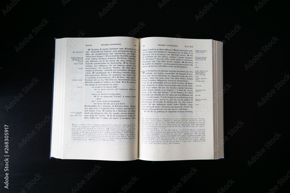 Flat lay open Bible, Greek New Testament. Novum Testamentum Graece. On black background. Baselland, Switzerland 12.05.2019 Flat lay open Bible, Greek New Testament. Novum Testamentum Graece. On black background. Baselland, Switzerland 12.05.2019