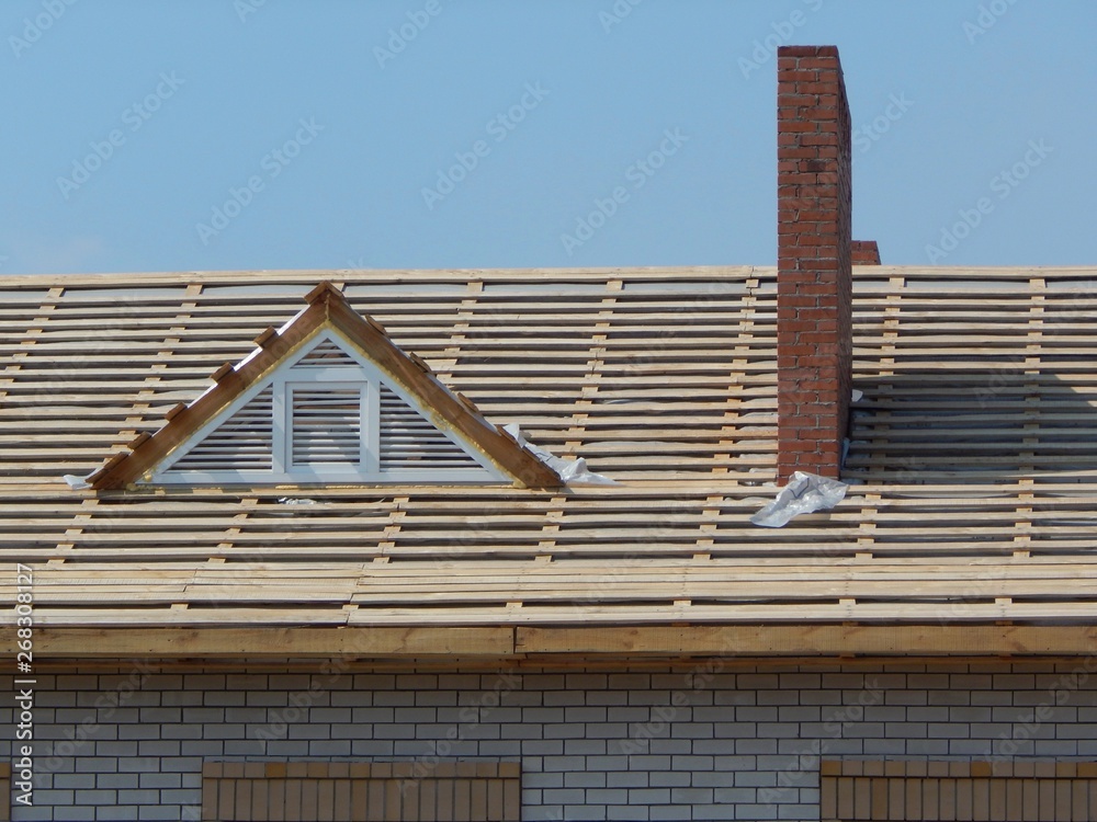 New wooden roof. Construction of cross beams, crossbars and roof ...
