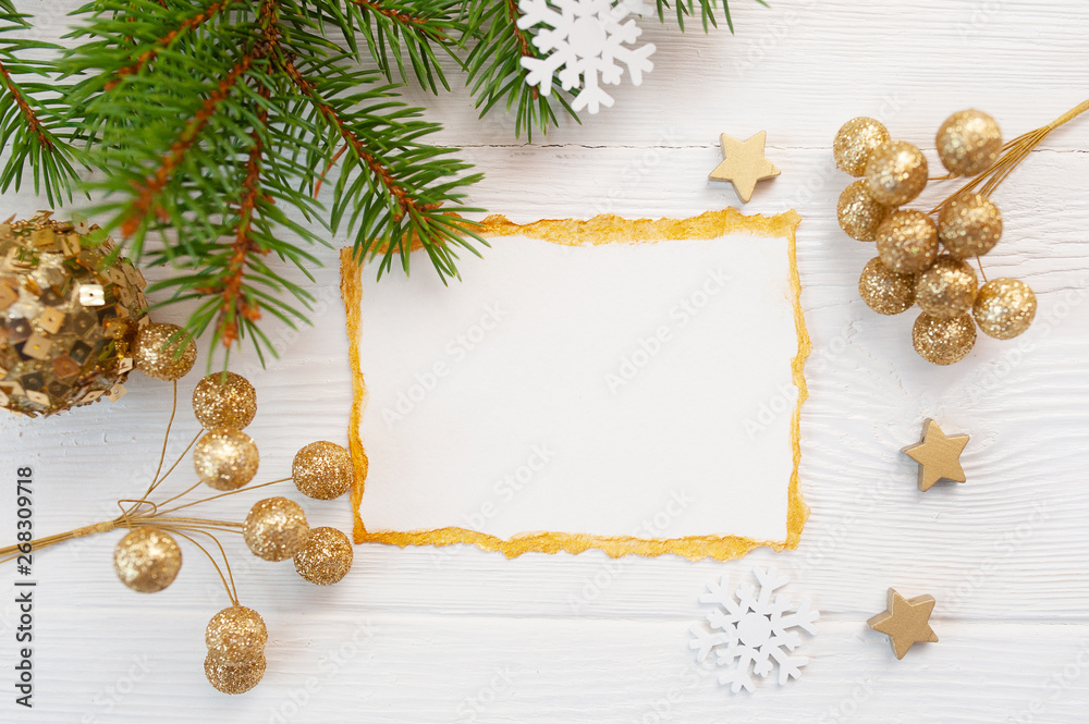 Christmas background for greeting card sheet of paper with place for text. x-mas tree, golden toys on wooden background. Flat lay, top view photo mockup