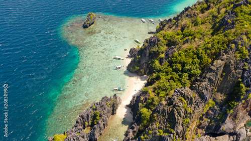 El Nido Palawan National Park Philippines. Warm hidden lagoon near the rocks. Tropical island with rocky shore and white beach. Tourist routes by boat.