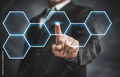 businessman touching virtual screen on hexagon