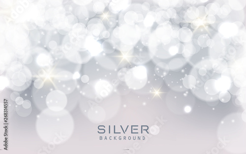 Silver abstract bokeh background sparkling lights effect. Blured circle on gray background.