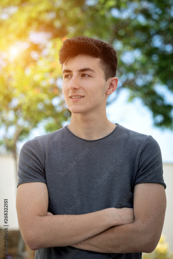 Attractive teenager guy in a park