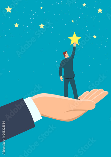 Giant hand helping a businessman to reach out for the stars