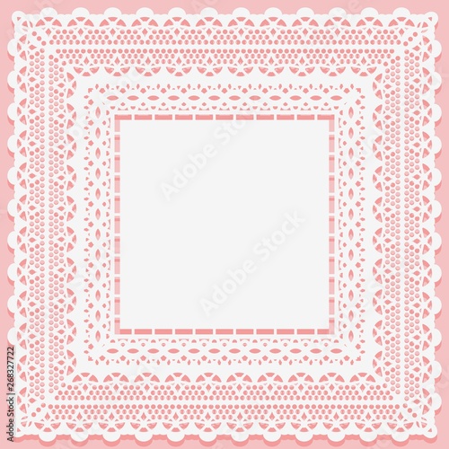 White lacy square doily isolated on a pink background. Openwork lace frame towel mat. photo