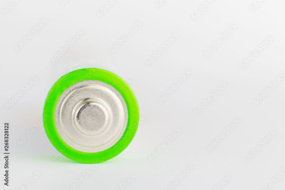 Alkaline batteries on the light background. The concept of recycling batteries, caring for the environment. Copy space. Macro photo. 