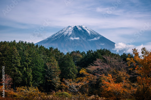 Mt. Fuji on blue sky background with autumn foliage at daytime in Fujikawaguchiko, Japan.