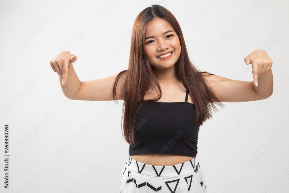 Beautiful young Asian woman point down to blank space. Beautiful young Asian woman point down to blank space.