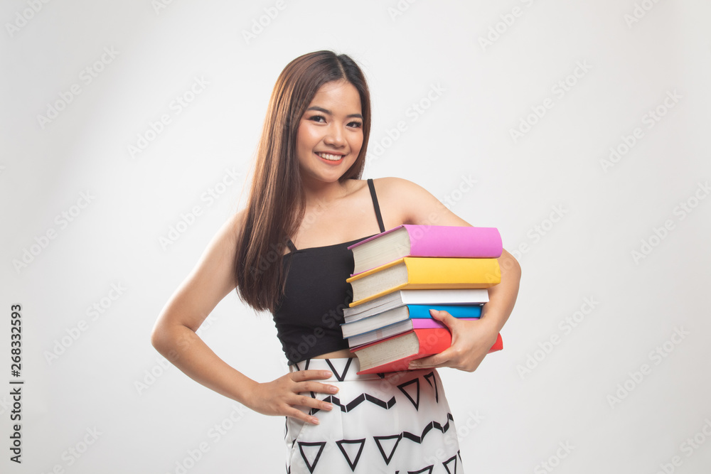 Young Asian woman studying with may books. Young Asian woman studying with may books.