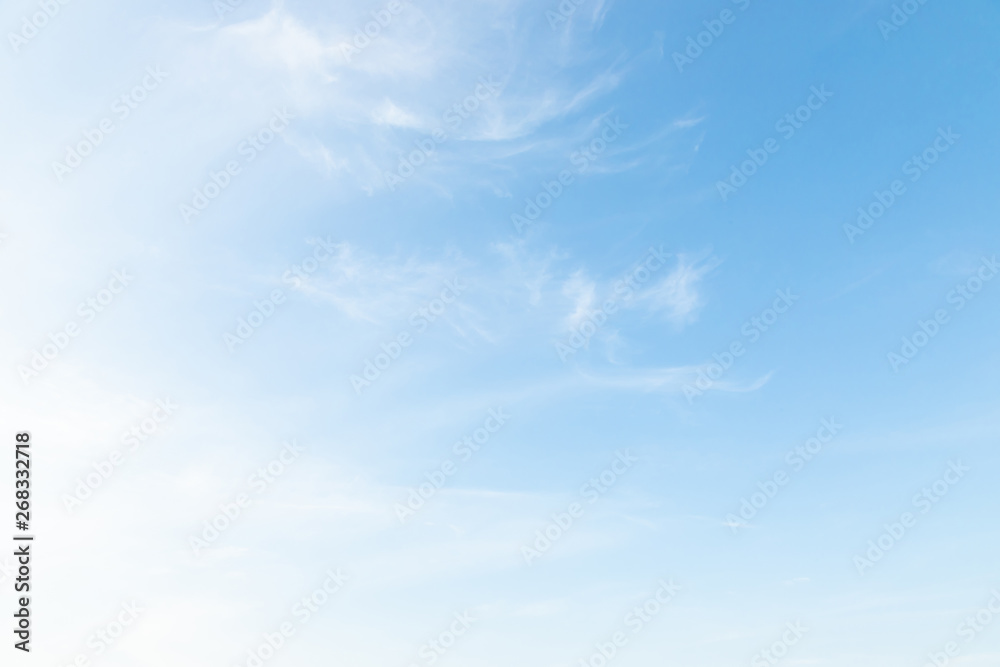 Fototapeta premium Beautiful clear blue sky background with plain large white cloud on morning time rays sunlight. space for text. soft focus.