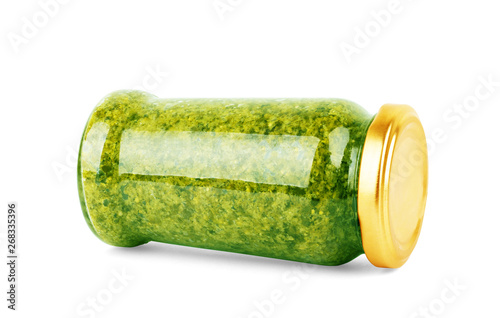 Homemade basil pesto sauce in glass jar on white background