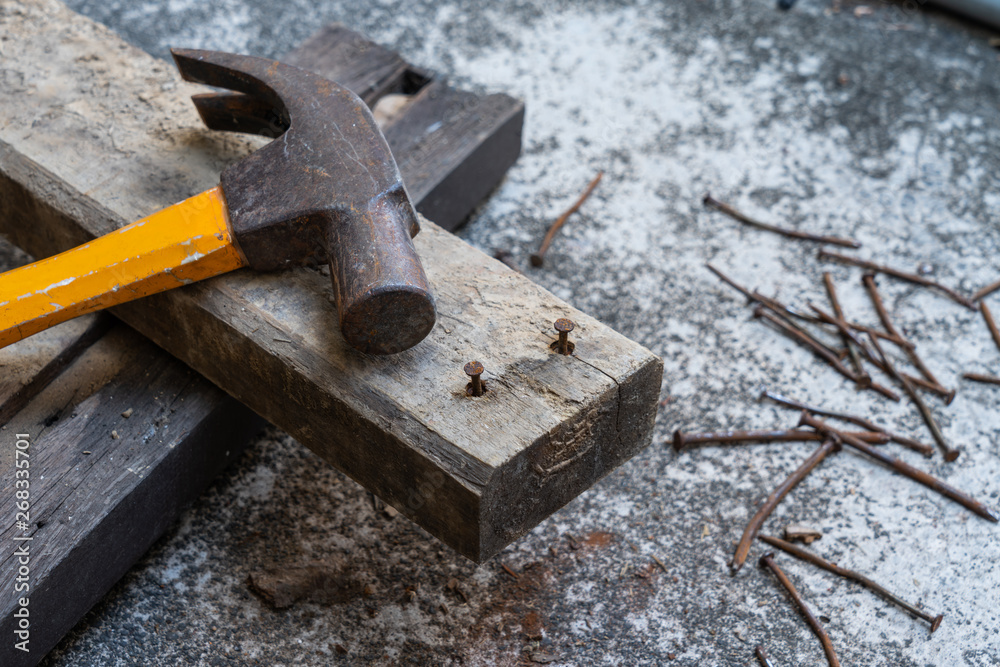 Hammer, rusty nail and wood for carpenter's job Hammer, rusty nail and wood for carpenter's job