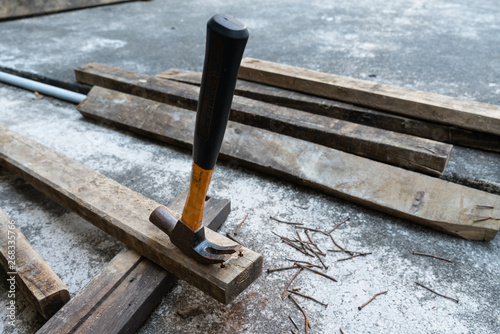 Hammer, rusty nail and wood for carpenter's job