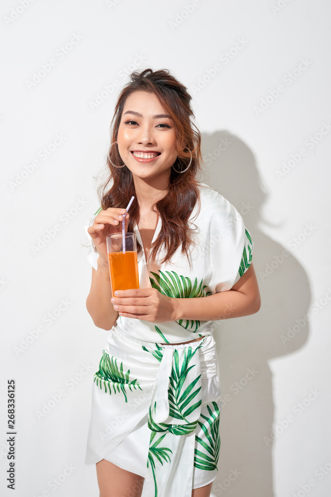 Happy Asian woman in summer casual clothes with a glass of fresh fruit juice drink Happy Asian woman in summer casual clothes with a glass of fresh fruit juice drink