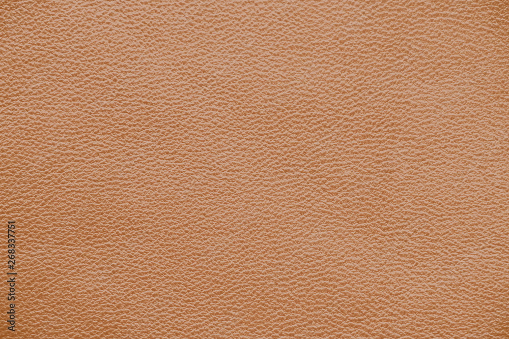 The texture of genuine leather. Brown background. The structure of the leather material brown shades. The texture of genuine leather. Brown background. The structure of the leather material brown shades.