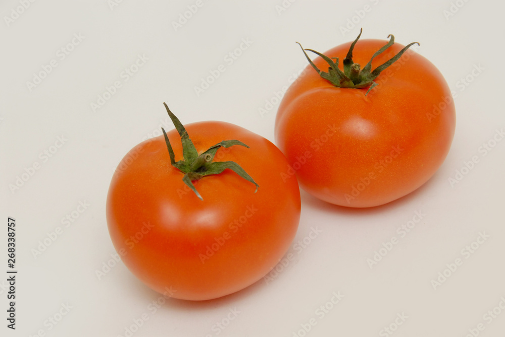 Fresh tomatoes isolated on the gray background Fresh tomatoes isolated on the gray background