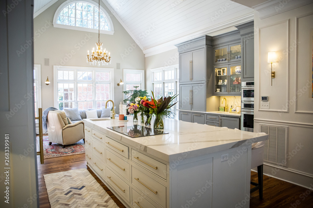 © Ursula Page - Open Concept Elegant and Spacious Kitchen with Marble Countertops, Chandelier, and Two Toned Cabinets