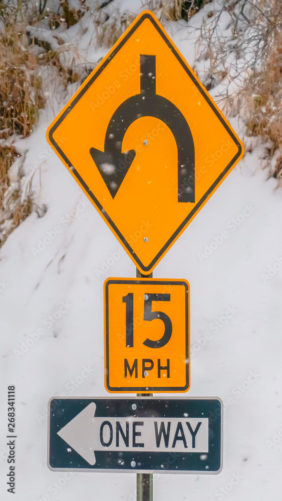 Vertical Road signs against snow covered slope in winter Vertical Road signs against snow covered slope in winter