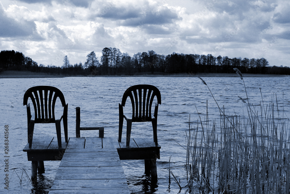 Two empty chairs on a fishing platform