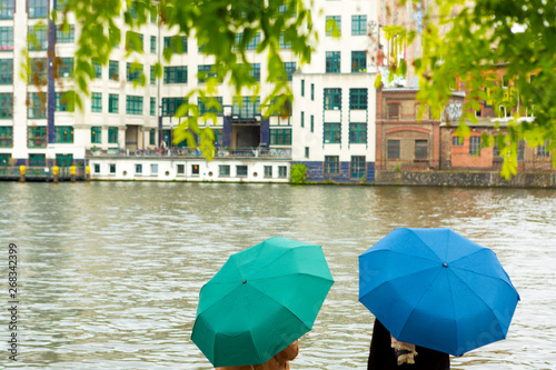Tourists enjoy the view of the Spree River in Berlin during rain