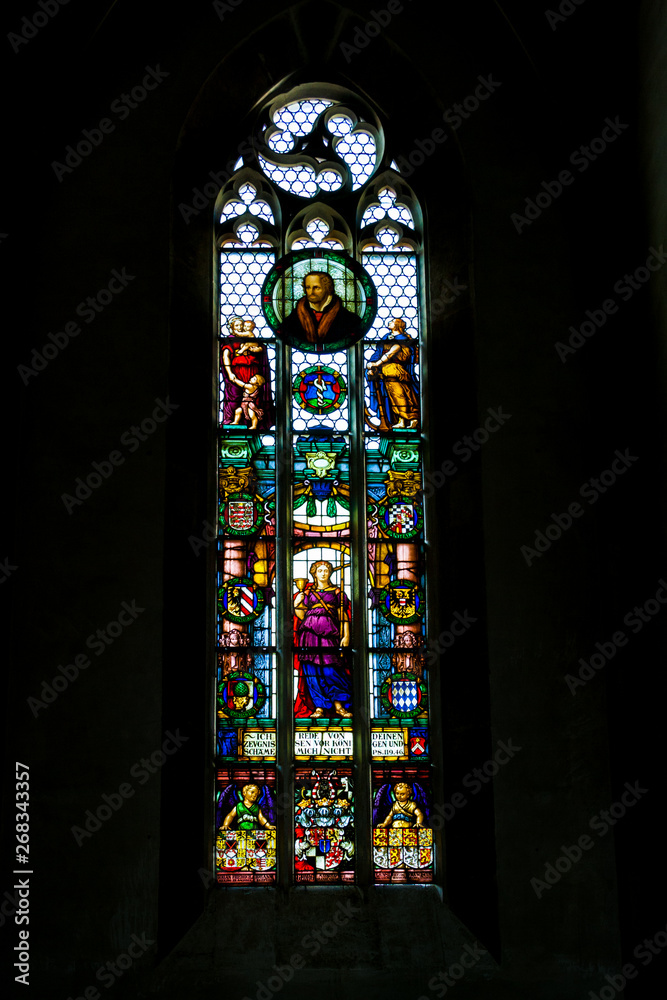 Beautiful stained glass church window depicting Psalm 119:46 from the St. James Church (St. Jakob), a historic Protestant church in Rothenburg ob der Tauber, Germany.