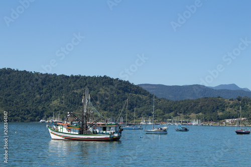 Beautiful landscape with ocean  boats and montains and blue sky.