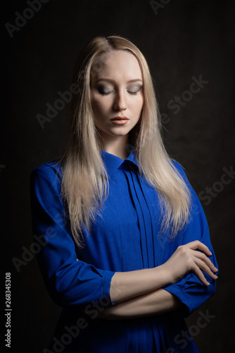 Portrait of beautiful young woman with blue eyes. Studio shot.