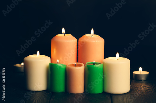 candles burning in darkness over black background. commemoration concept.