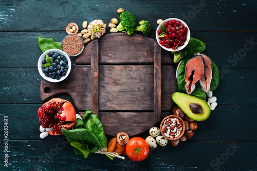 Food for heart health: Fish, blueberries, nuts, pomegranate, avocados, tomatoes, spinach, flax. The concept of healthy eating.