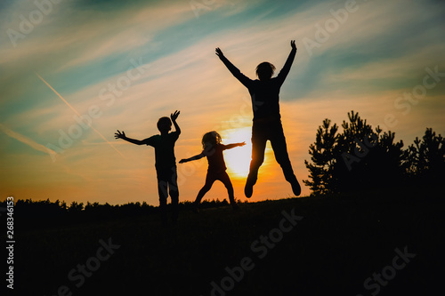 happy family enjoy nature, father and kids play at sunset