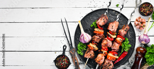 Pork shish kebab with onions and tomatoes. Barbecue. Top view. Free space for your text. Rustic style.