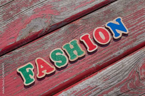 word fashion made of color letters on wooden bench