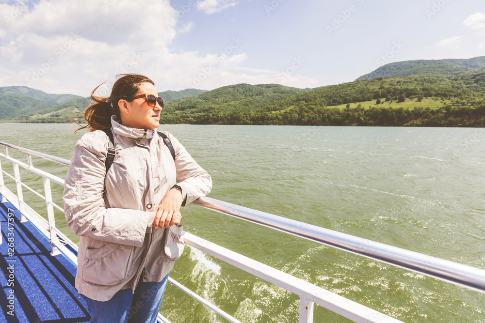 Fototapeta premium Happy tourist woman enjoy view of Danube river at cruise ship