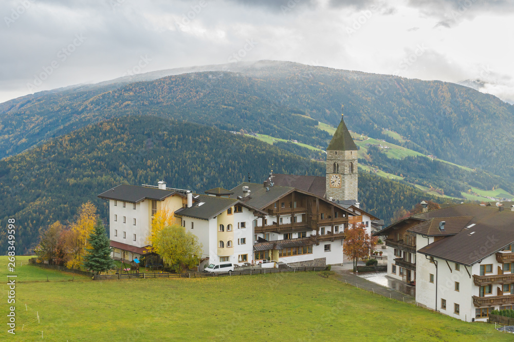 Picturesque autumnal view on San Giacomo church of Maranza / Meransen, alpine plateau in South Tyrol. Mountain scenery in Northern Italy. Calm morning landscape, peaceful location.