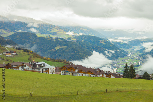 Picturesque autumnal view on green meadow of Maranza / Meransen, alpine plateau in South Tyrol. Mountain scenery in Northern Italy. Calm morning landscape, peaceful location.