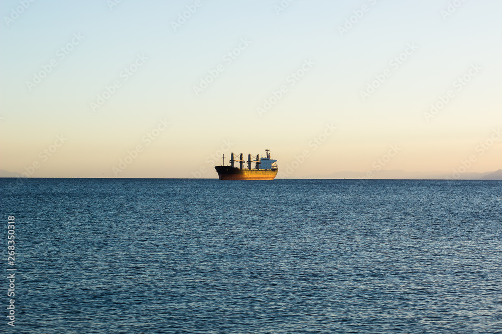 cargo industrial ship in Atlantic ocean water environment scenery landscape, idyllic transportation simple picture with empty copy space for text