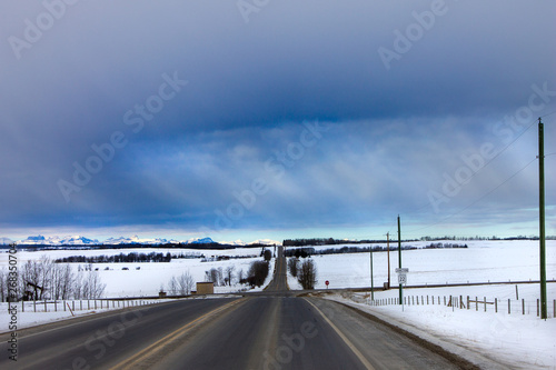 country road with dark clouds