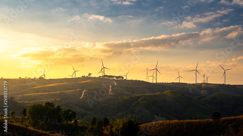 Wind turbines and Orange sunset sky. Beautiful mountain landscape with wind generators turbines,Thailand. Renewable energy concept. 