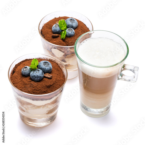 Classic tiramisu dessert with blueberries in a glass and cup of coffee isolated on a white background with clipping path