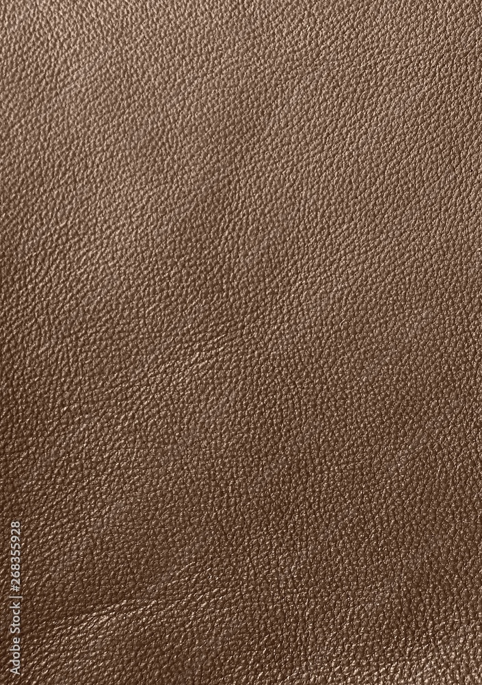 Fototapeta premium The texture of genuine leather. Impeccable and stylish background. Beautiful stylish background. Natural skin texture close up. Brown background. The structure of the leather material brown shades.