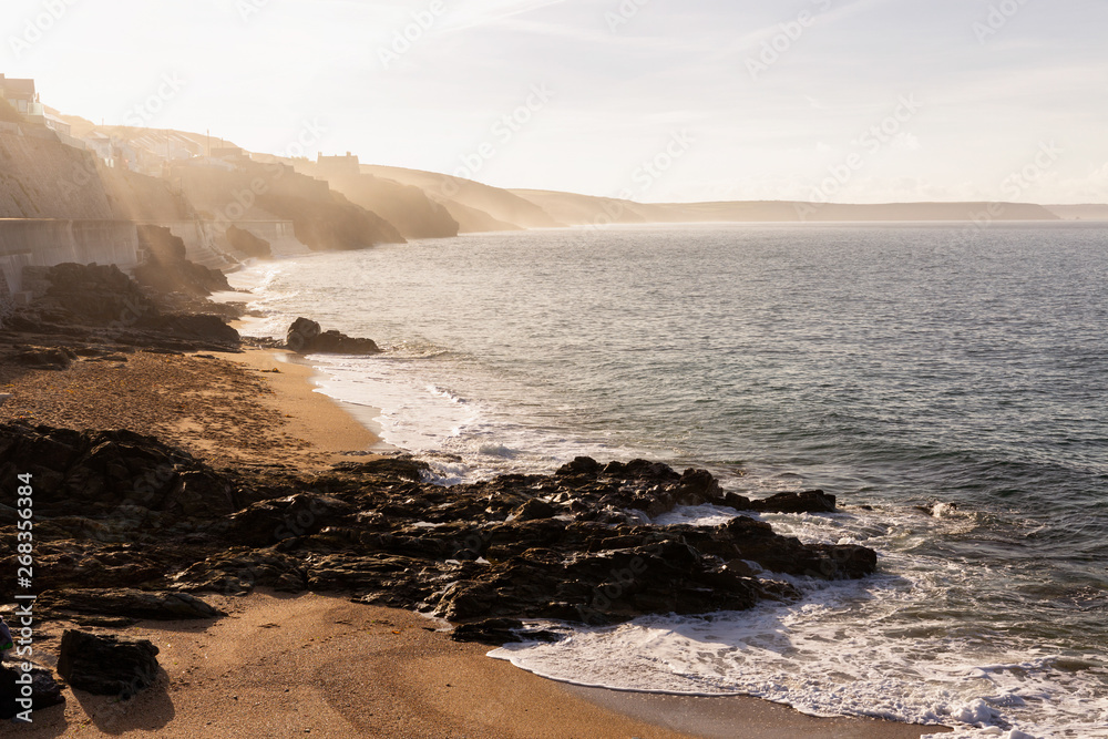 Obraz premium Morning mist on the cliffs along Porthleven Sands in Cornwall, England, UK.