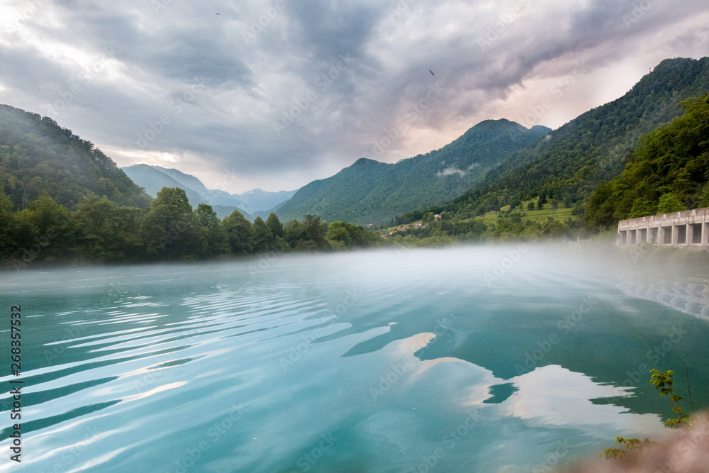 Foggy lake with moving water in Triglav national park in the Julian Alps, Slovenia