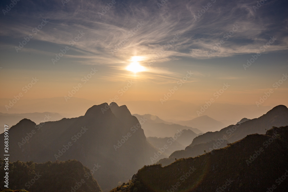 sunset in mountains with shadow layer