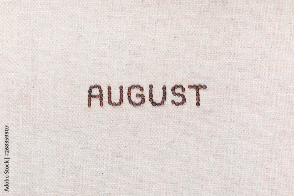 The word August written with coffee beans shot from above, aligned in the center.