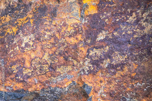 Rusty texture. Stone rusty background. Colorful granite stone background. Old Cracked Rusty Rough texture. Rock wall backdrop with rough red brown texture. Grunge Abstract Stone Surface. 