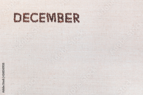 The word December written with coffee beans shot from above, aligned at the top left.