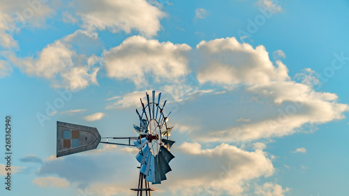 Panorama Windpump with a snow covered mountain and cloudy blue sky in the background