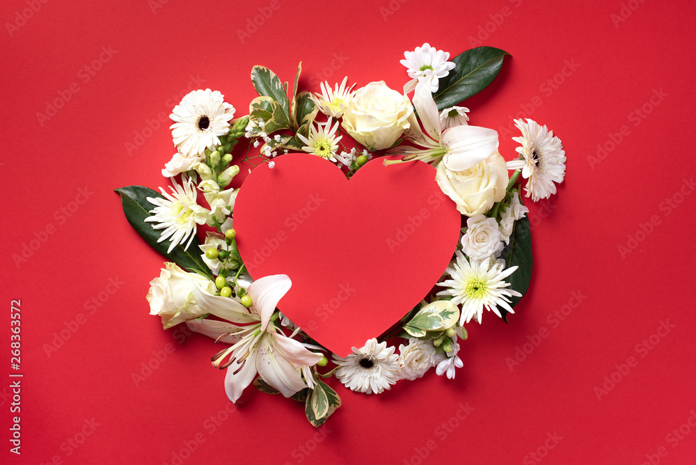 Creative layout with white flowers, paper heart over red background. Top view, flat lay. Spring and summer concept. Creative layout with white flowers, paper heart over red background. Top view, flat lay. Spring and summer concept.